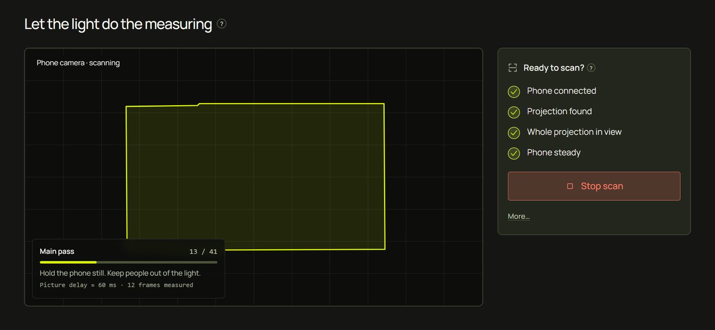 The laptop during the scan: Main pass with a progress bar and Hold the phone still